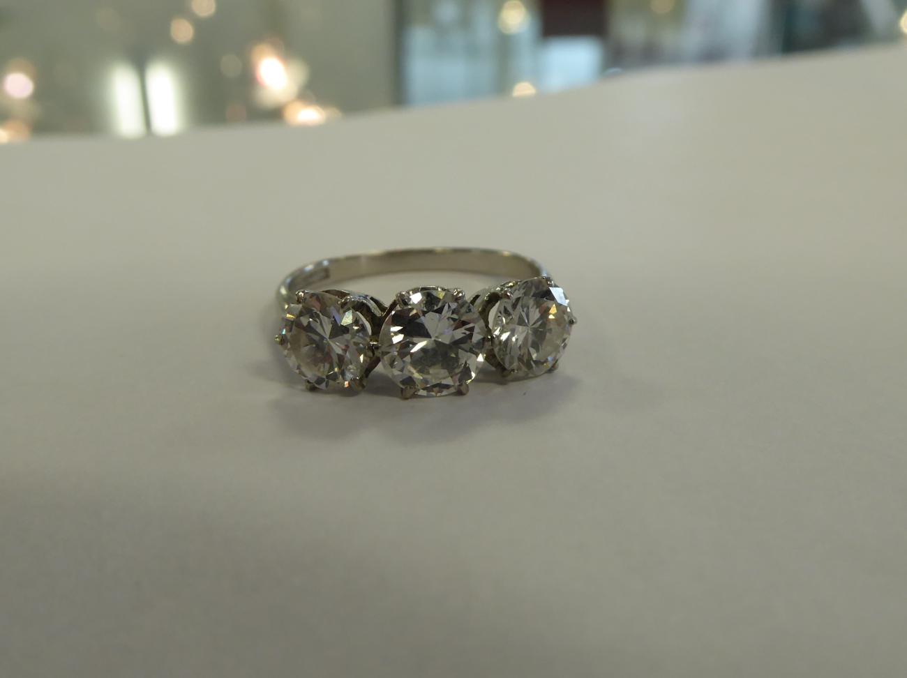 A Diamond Three Stone Ring, round transitional cut diamonds in claw settings, to knife edge - Image 3 of 6