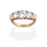 A Diamond Five Stone Ring, graduated old mine cut diamonds, with single-cut diamond accents, to a