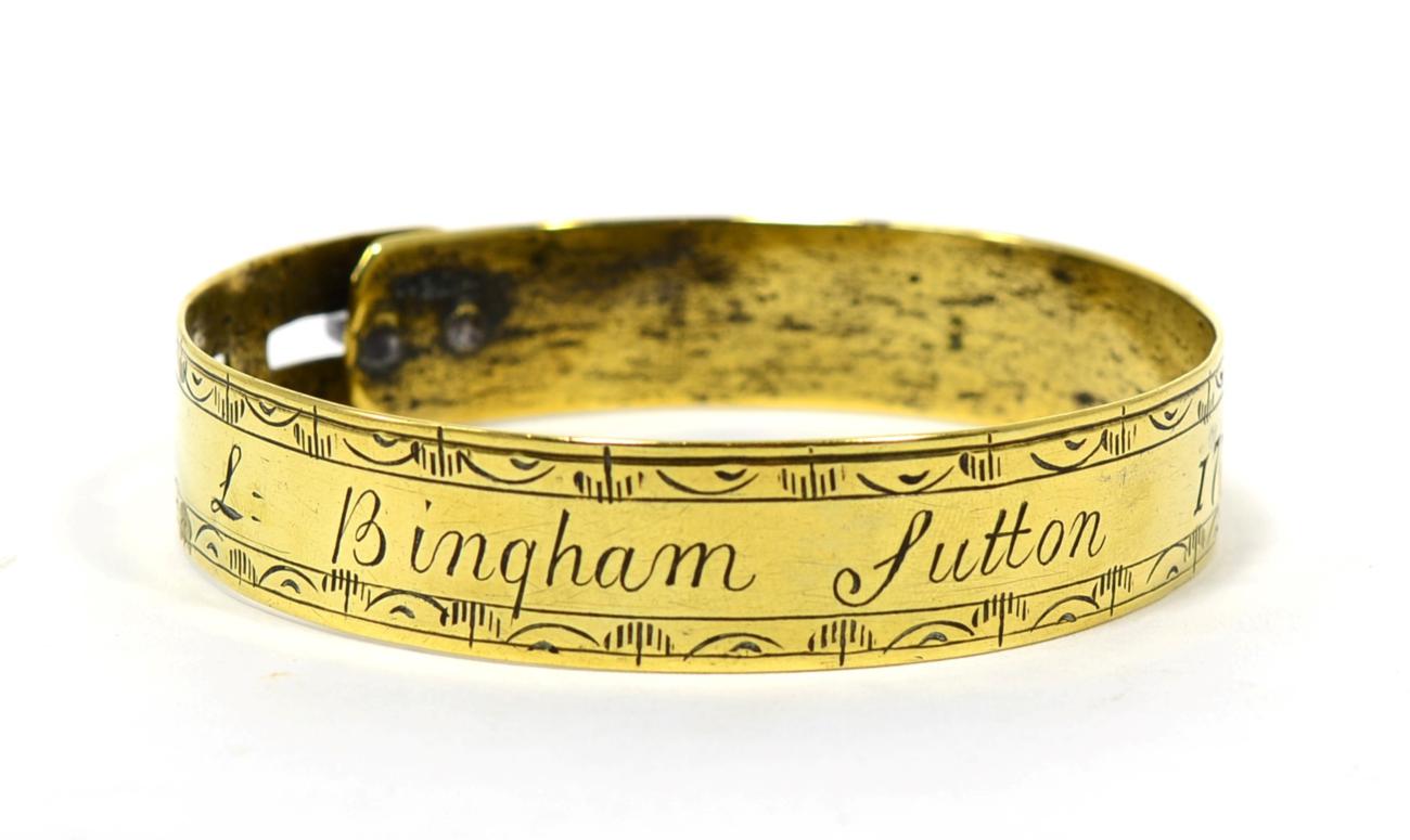 A George III Brass Dog Collar, inscribed L Bingham Sutton 1772 within engraved leaf borders, 8.5cm