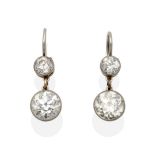 A Pair of Old Cut Diamond Drop Earrings, an old cut diamond in a white milgrain setting suspends a