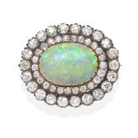 An Opal and Diamond Brooch/Pendant, an oval cabochon opal in a claw setting, within a two tier