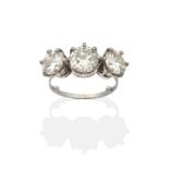 A Diamond Three Stone Ring, graduated round brilliant cut diamonds in claw settings, to knife edge