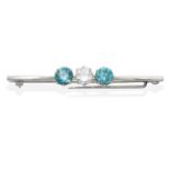 A Diamond and Blue Zircon Bar Brooch, a round brilliant cut diamond spaced by round cut blue