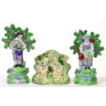 A Pair of Salt Pearlware Figures of Gardeners, circa 1810, he with a basket of flowers and a