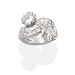 An 18 Carat White Gold Diamond Crossover Ring, two round brilliant cut diamonds, in claw settings,