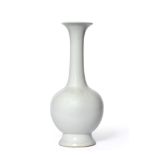 A Chinese Porcelain Bottle Vase, Xuande reign mark, the tall slender neck carved with bands of