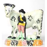 A Yorkshire Prattware Cow Group, circa 1800, modelled as a cowherd standing beside a cow, a calf