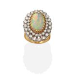 An 18 Carat Gold Opal and Diamond Cluster Ring, an oval cabochon opal in a claw setting within a two