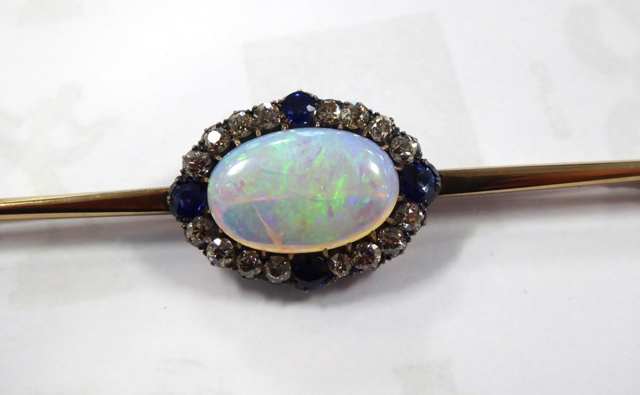 A Black Opal, Diamond and Sapphire Bar Brooch, an oval cabochon black opal, in a claw setting, - Image 2 of 5