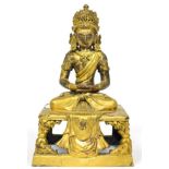 A Gilt Bronze Figure of Buddha, probably Tibet, 17th century, seated with headdress and loose robes,