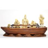 A Japanese Ivory and Hardwood Okimono, Meiji period, as a dignitary and two attendant musicians on a