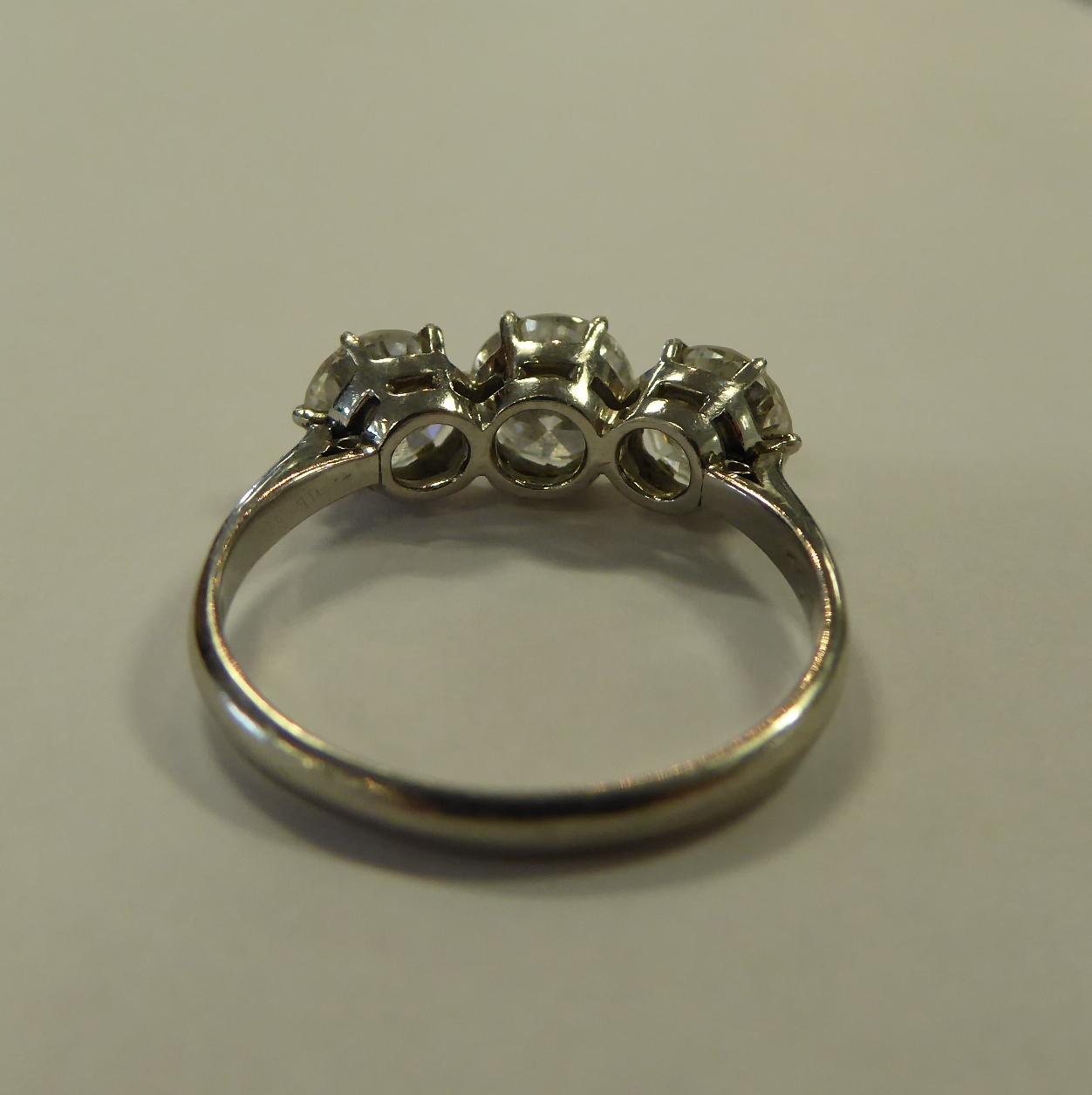 A Diamond Three Stone Ring, round transitional cut diamonds in claw settings, to knife edge - Image 5 of 6