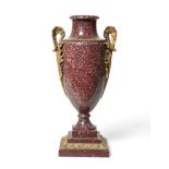 A Gilt Metal Mounted Porphyry Urn Shaped Vase, 19th century, with leaf scroll handles, on a