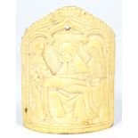 A French Ivory Plaque, in 14th century style, carved in low relief with the Pieta flanked by two