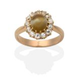 A Cats-Eye Chrysoberyl and Diamond Cluster Ring, a round cabochon cats-eye chrysoberyl in a claw