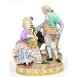 A Meissen Porcelain Figure Group of Lovers, circa 1880, he standing holding a basket of flowers, she