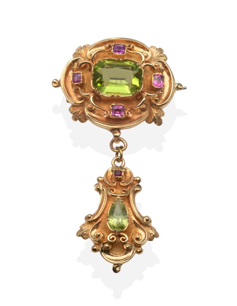 A Victorian Peridot and Ruby Brooch, a cushion cut peridot and four rubies in a carved quatrefoil