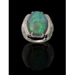 An Art Deco Style Black Opal and Diamond Ring, an oval cabochon black opal in a claw setting to