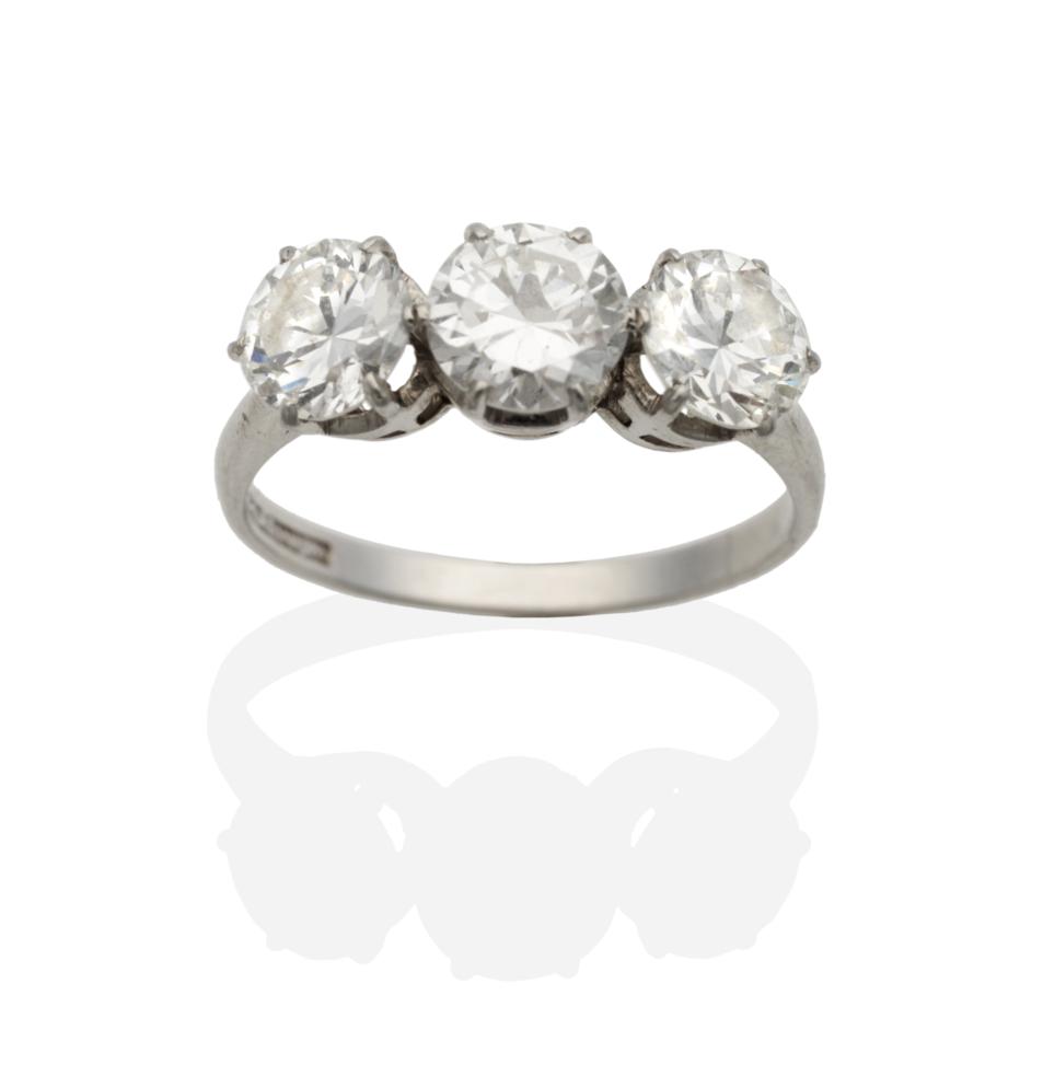 A Diamond Three Stone Ring, round transitional cut diamonds in claw settings, to knife edge