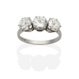 A Diamond Three Stone Ring, round transitional cut diamonds in claw settings, to knife edge