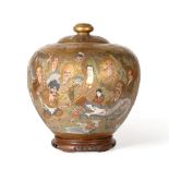 A Satsuma Earthenware Ovoid Jar and Cover, Meiji period, typically painted with immortals below a