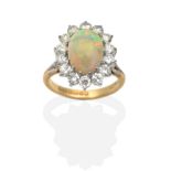 An 18 Carat Gold Opal and Diamond Cluster Ring, an oval cabochon opal within a border of round