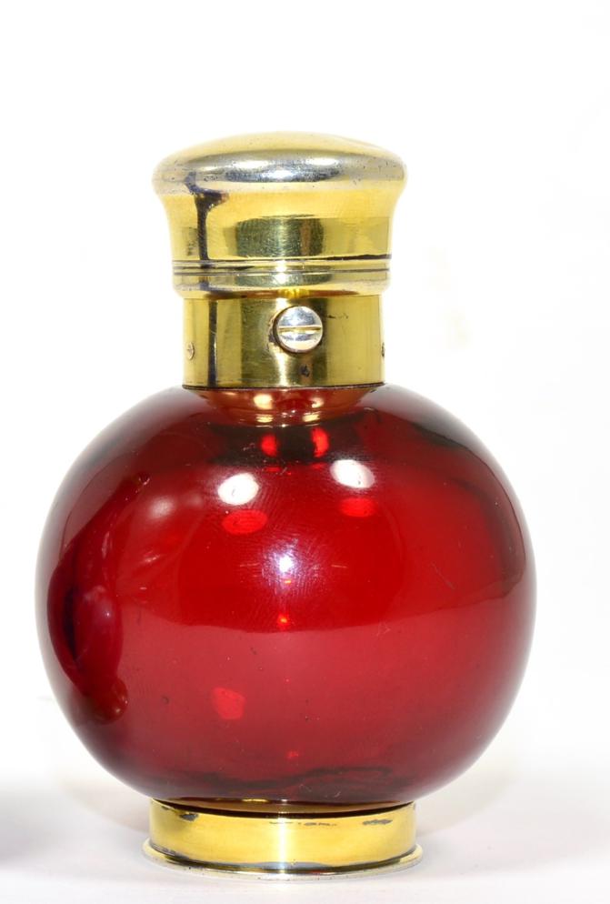 A Late Victorian Gilt White Metal Ruby Glass Scent Bottle, of ovoid form with hinged cover and