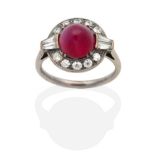 An Art Deco Ruby and Diamond Ring, a high domed round cabochon ruby within a border of old cut and