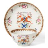 A Chinese Armorial Porcelain Tea Bowl and Saucer, Qianlong, painted in famille rose enamels with the