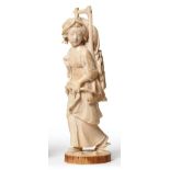 A Japanese Ivory Okimono, Meiji period, as a girl in flowing robes carrying a basketwork panier,