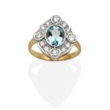 An Aquamarine and Diamond Cluster Ring, an oval cut aquamarine within a round brilliant cut