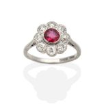 A Ruby and Diamond Cluster Ring, a round cut ruby within a border of milgrain set old cut