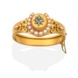 A Victorian Emerald, Pearl and Diamond Bangle, a domed centre with an octagonal cut emerald to a