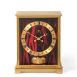 A Brass Red Faux Marble Panel Atmos Clock, signed Jaeger LeCoultre, model: Embassy Red, second