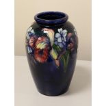 Walter Moorcroft (British, 1917-2002): An Orchid and Spring Flowers Pattern Vase, on a blue