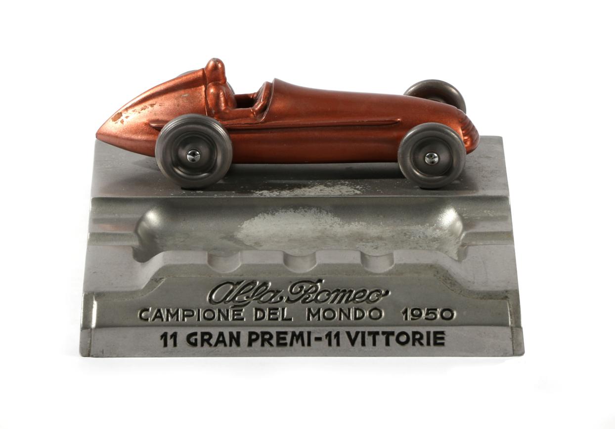 A Rare 1950 Alfa Romeo Cast Metal Ashtray, of moulded form and surmounted with a model of an Alfa