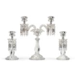 A Baccarat glass three piece garniture, 20th century, with lobed sconces hung with prismatic drops