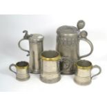 An 18th/19th century pewter tankard, three 18th century pewter graduated tankards and a flagon