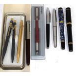 A Parker fountain pen with nib stamped 18k/750 and mottled blue case, a Parker fountain pen with nib