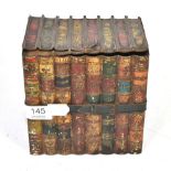 A tole ware biscuit tin in the form of a stack of books