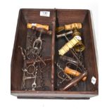 A collection of nineteen vintage corkscrews and a mahogany cutlery tray