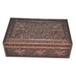 An ornately carved wooden box decorated with foliage and an emblem for the Rifle Brigade