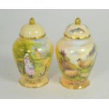 A pair of hand painted vases and covers, one decorated with sheep in a landscape, another a girl