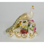 A Royal Crown Derby Sitting Peacock model, with green printed mark, 18cm