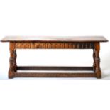 A Carved Oak Joint Stool, the one piece top above a nulled frieze, raised on carved and fluted