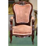 A Victorian Child's Carved Mahogany Fauteuil, circa 1870, upholstered in pink velvet, with an