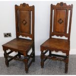 A Pair of Early 18th Century Joined Oak, Ebonised and Parquetry Decorated Hall Chairs, with shaped