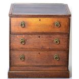 An Early 19th Century Oak Clerk's Desk, with leather writing slope above three deep drawers,