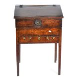 A George III Oak Estate Clerk's Desk, late 18th/early 19th century, with hinged lid enclosing six