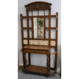 A Victorian Oak and Tiled-Back Hallstand, late 19th century, with moulded and fluted pediment with